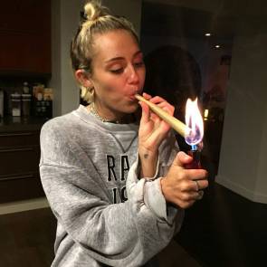 Miley Cyrus lighting the big cigarette