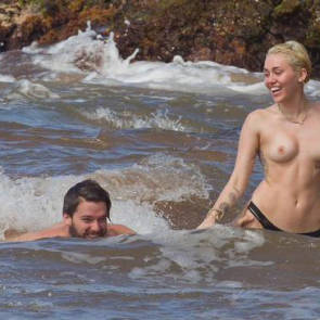 Miley Cyrus Topless on with boyfriend on beach
