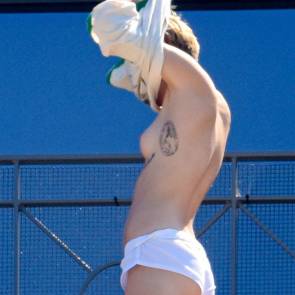 Miley Cyrus topless with shirt over her head